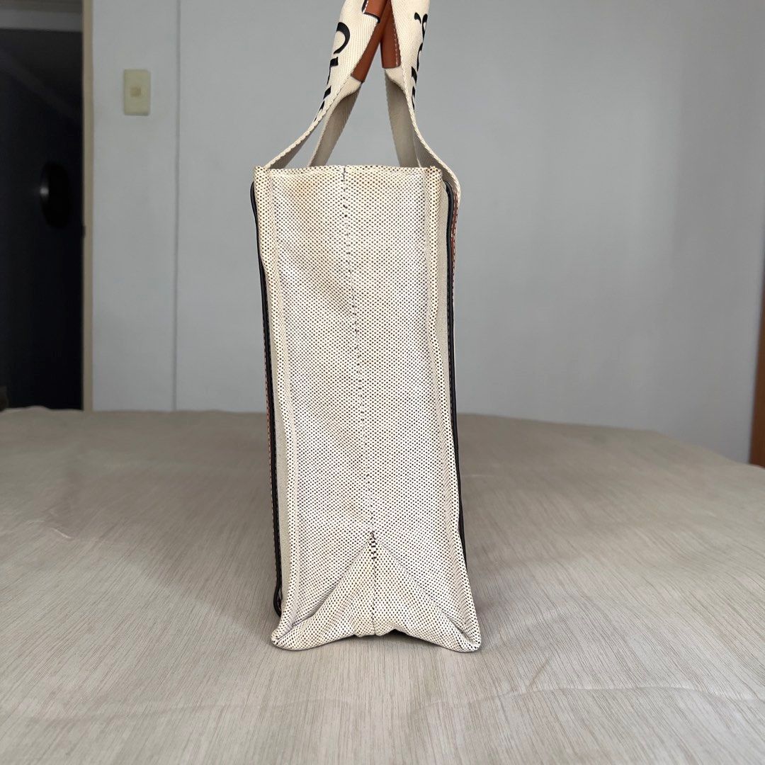 Chloe Woody Canvas Tote Bag (Category: Luxury Bags & Wallets) located in Pasig City. Submitted by jenscloset86 (Listing ID 1464436689, Image 2). Description: CHLOE Woody Canvas Tote Bag • Spacious interior with a practical flat pocket. • Used item but in a very good condition. • 9/10 rating. Good condition. Measurement in inches): Length: 14” Height: 10” Bottom: 4.5” - Chloe canvas tote bag - Iconic Chloe logo on straps - Spacious interior with c