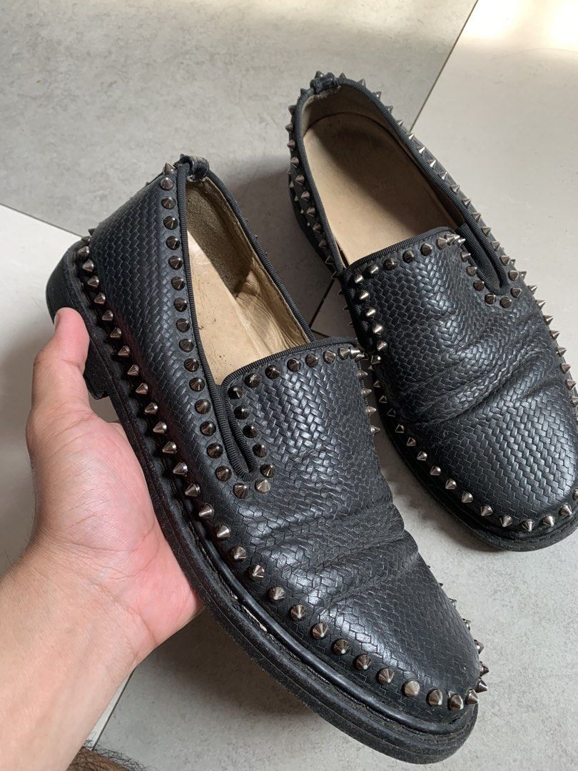 Christian Louboutin Roller Boat (Category: Casual Shoes) located in Taguig. Submitted by pili_na.ph (Listing ID 1464503763, Image 1). Description: - Black slip-on loafers - Silver stud detailing around the shoe - Textured leather-like material - Minor creasing on the top surface - Ideal for creating a bold and edgy look.
