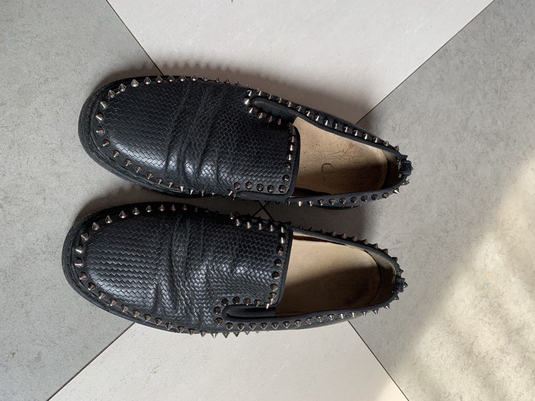 Christian Louboutin Roller Boat (Category: Casual Shoes) located in Taguig. Submitted by pili_na.ph (Listing ID 1464503763, Image 2). Description: - Black slip-on loafers - Silver stud detailing around the shoe - Textured leather-like material - Minor creasing on the top surface - Ideal for creating a bold and edgy look.