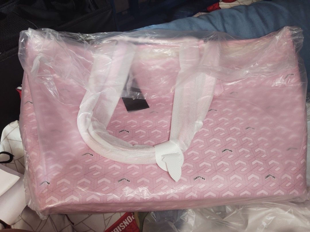 Christy Ng Pink Monogram Tote Bag (Category: Tote Bags) located in Pasig City. Submitted by jezreel03062608 (Listing ID 1464355897, Image 1). Description: - Stylish pink tote bag with authentic Christy Ng monogram pattern. - Spacious interior, ideal for everyday essentials or travel. - Comes with original dust bag and receipt for authenticity. - Limited edition - Handles are wrapped for added protection..