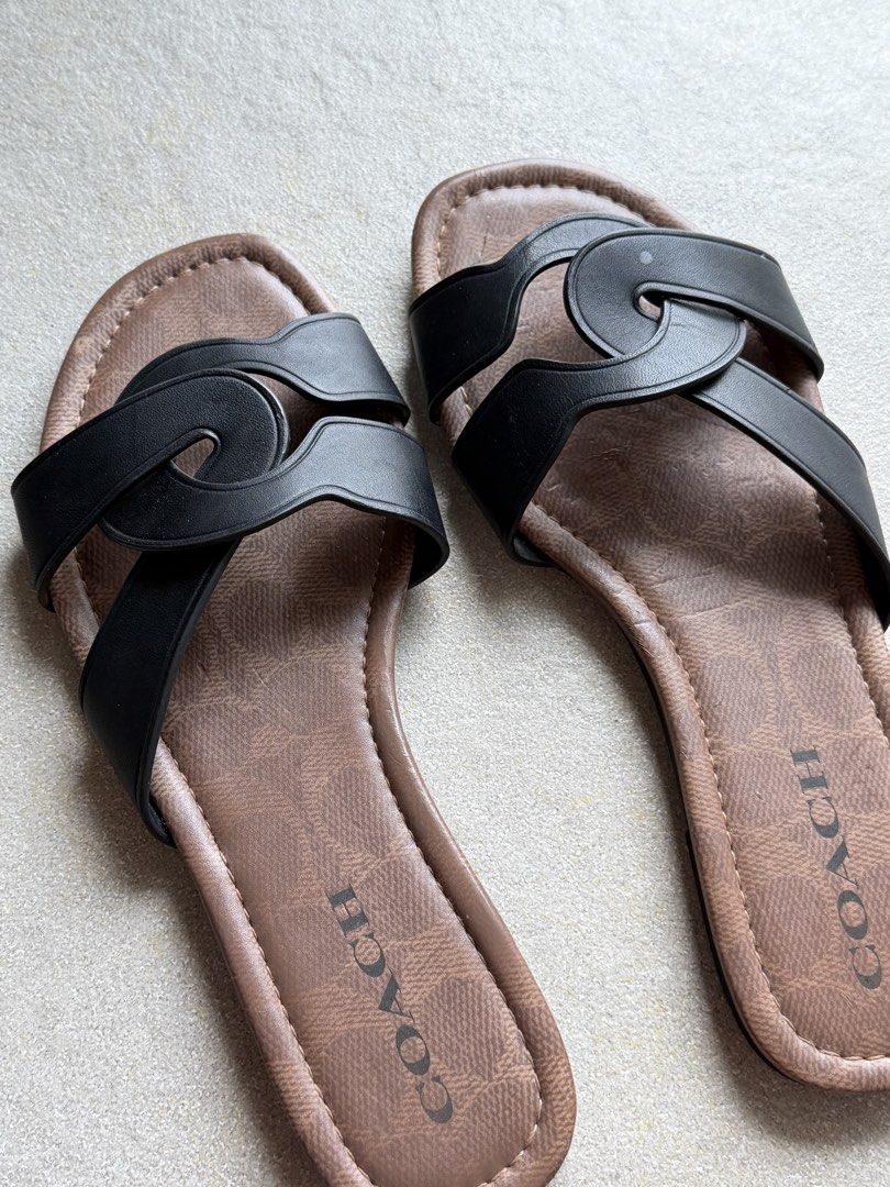 Coach Black & Brown Monogram Slide Sandals (Category: Flats & Sandals) located in Cebu City. Submitted by glenjlieza (Listing ID 1464428745, Image 2). Description: - Authentic Coach slide sandals - Classic black straps with signature Coach monogram pattern - Comfortable brown footbed - Easy slip-on design - Durable soles with Coach branding and size details - Ideal for everyday casual wear - With flaw (chipped leather).