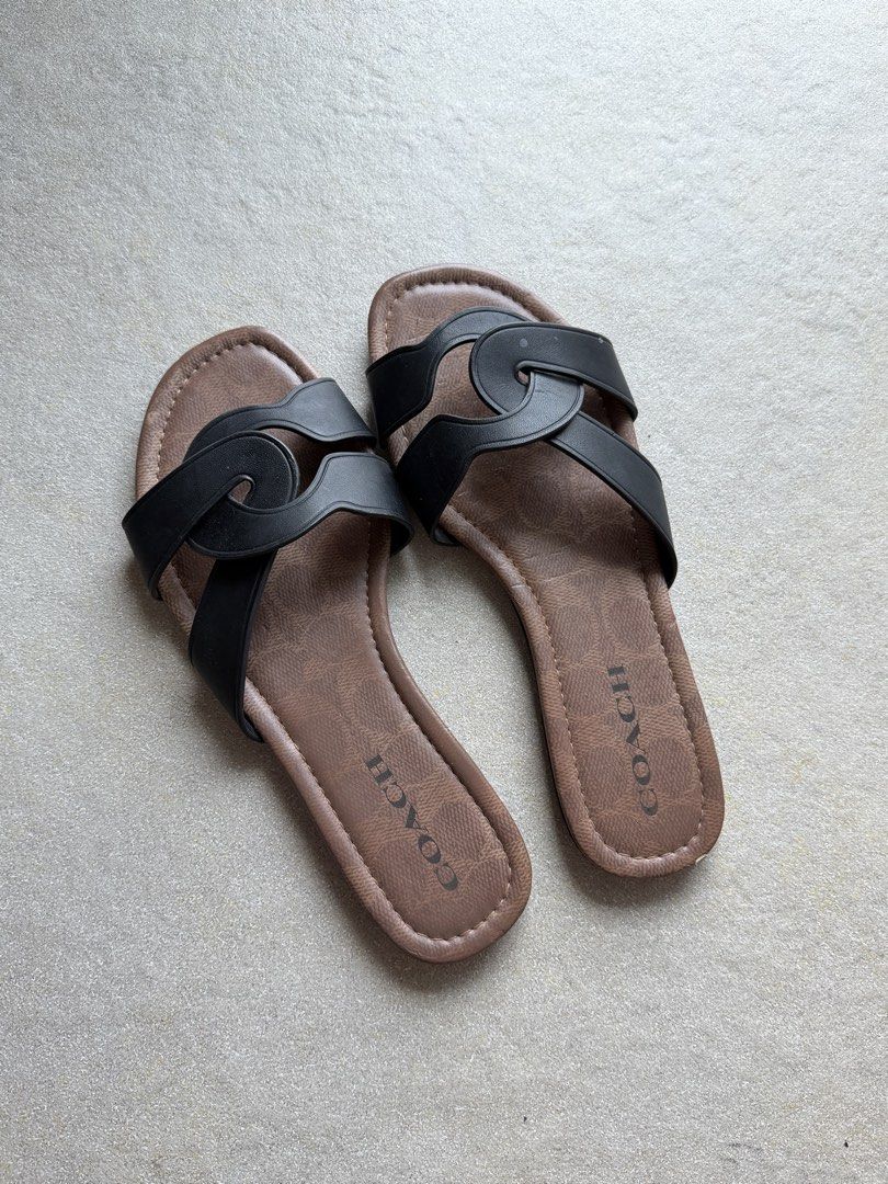 Coach Black & Brown Monogram Slide Sandals (Category: Flats & Sandals) located in Cebu City. Submitted by glenjlieza (Listing ID 1464428745, Image 1). Description: - Authentic Coach slide sandals - Classic black straps with signature Coach monogram pattern - Comfortable brown footbed - Easy slip-on design - Durable soles with Coach branding and size details - Ideal for everyday casual wear - With flaw (chipped leather).