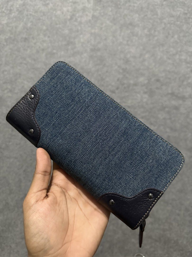 Coach Denim and Leather Zip Around Wallet (Category: Wallets & Card holders) located in Villasis. Submitted by justinramosonfb (Listing ID 1464508745, Image 2). Description: - Coach wallet - Denim and dark leather accents - Secure turn-lock closure - Ample space for cards and cash - Perfect for everyday use - Shows some signs of wear, but plenty of life left.