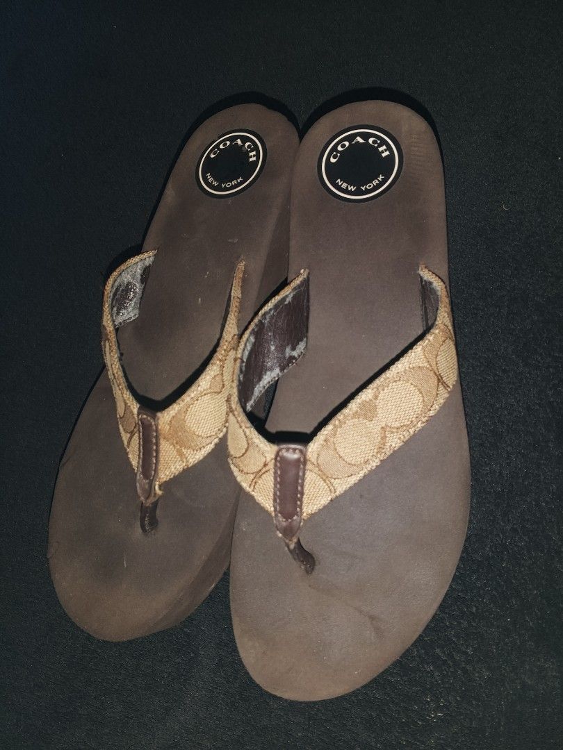 Coach Flip Flops & Embellished Crocs (Category: Slippers and slides) located in Panitan. Submitted by danieldeju29592 (Listing ID 1464406876, Image 1). Description: - Coach flip flops: Brown with signature C print, size 7. Note: some wear on straps. - Black Crocs: Decorated with charms and a chain, size 7. Perfect for casual wear..