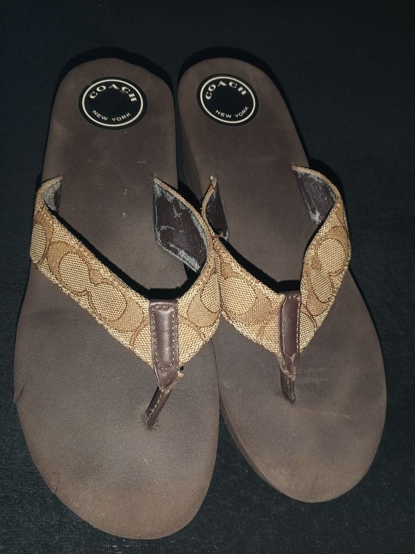 Coach Flip Flops & Embellished Crocs (Category: Slippers and slides) located in Panitan. Submitted by danieldeju29592 (Listing ID 1464406876, Image 2). Description: - Coach flip flops: Brown with signature C print, size 7. Note: some wear on straps. - Black Crocs: Decorated with charms and a chain, size 7. Perfect for casual wear..