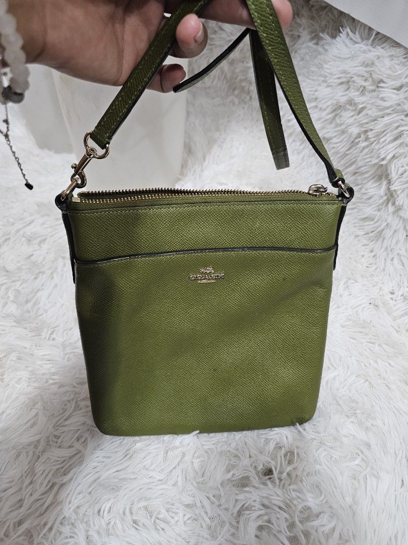 Coach Green Leather Crossbody Bag (Category: Cross-body Bags) located in Cavite. Submitted by liveriver_514fd1 (Listing ID 1464399916, Image 3). Description: - Authentic Coach crossbody bag - Beautiful green color - Genuine textured leather - Secure top zip closure - Adjustable strap for comfortable wear - Stylish gold hardware accents - Ideal for everyday use and casual outings.