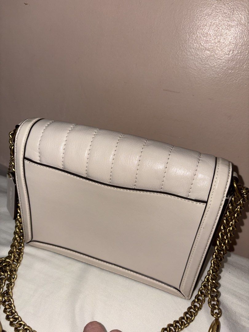 Coach Hutton Quilted Leather Shoulder Bag with Chain Strap (Category: Luxury Bags & Wallets) located in Munoz. Submitted by meowmeowmeowmeowz (Listing ID 1464480234, Image 3). Description: SRP 24k+ -Creamy white quilted leather shoulder bag by Coach - Gold turn-lock closure with iconic horse and carriage logo - Comfortable chain strap with leather shoulder pad - Interior zip pocket for essentials - Coach creed patch for authenticity - Versatile s