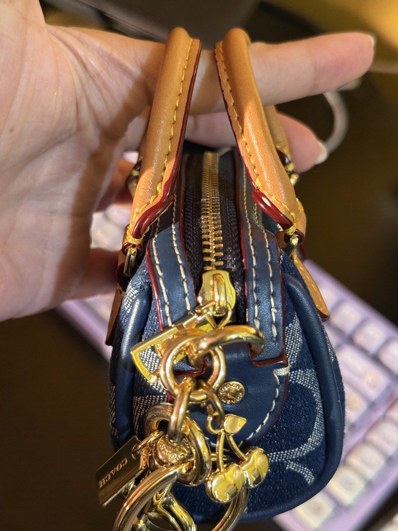 Coach Mini Rowan Bag Charm (Category: Luxury Bags & Wallets) located in Cabuyao City. Submitted by nethcantalejo8888 (Listing ID 1464567170, Image 3). Description: Original Coach Mini Rowan Bag Charm in Signature Denim ✨ An adorable miniature satchel featuring the brand’s classic blue jacquard fabric and rich tan leather top handles. Used once. Can be declared as brand new. Opened to check only. So unique and cute in actual. 💖 🌸 shipping via J&