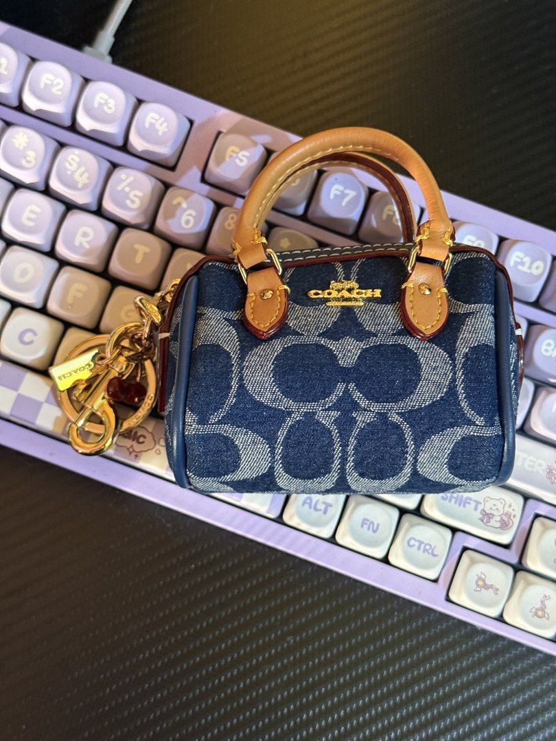 Coach Mini Rowan Bag Charm (Category: Luxury Bags & Wallets) located in Cabuyao City. Submitted by nethcantalejo8888 (Listing ID 1464567170, Image 1). Description: Original Coach Mini Rowan Bag Charm in Signature Denim ✨ An adorable miniature satchel featuring the brand’s classic blue jacquard fabric and rich tan leather top handles. Used once. Can be declared as brand new. Opened to check only. So unique and cute in actual. 💖 🌸 shipping via J&