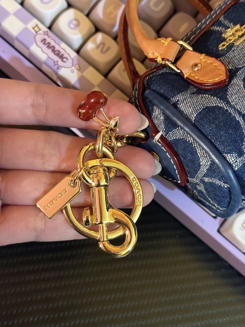 Coach Mini Rowan Bag Charm (Category: Luxury Bags & Wallets) located in Cabuyao City. Submitted by nethcantalejo8888 (Listing ID 1464567170, Image 2). Description: Original Coach Mini Rowan Bag Charm in Signature Denim ✨ An adorable miniature satchel featuring the brand’s classic blue jacquard fabric and rich tan leather top handles. Used once. Can be declared as brand new. Opened to check only. So unique and cute in actual. 💖 🌸 shipping via J&