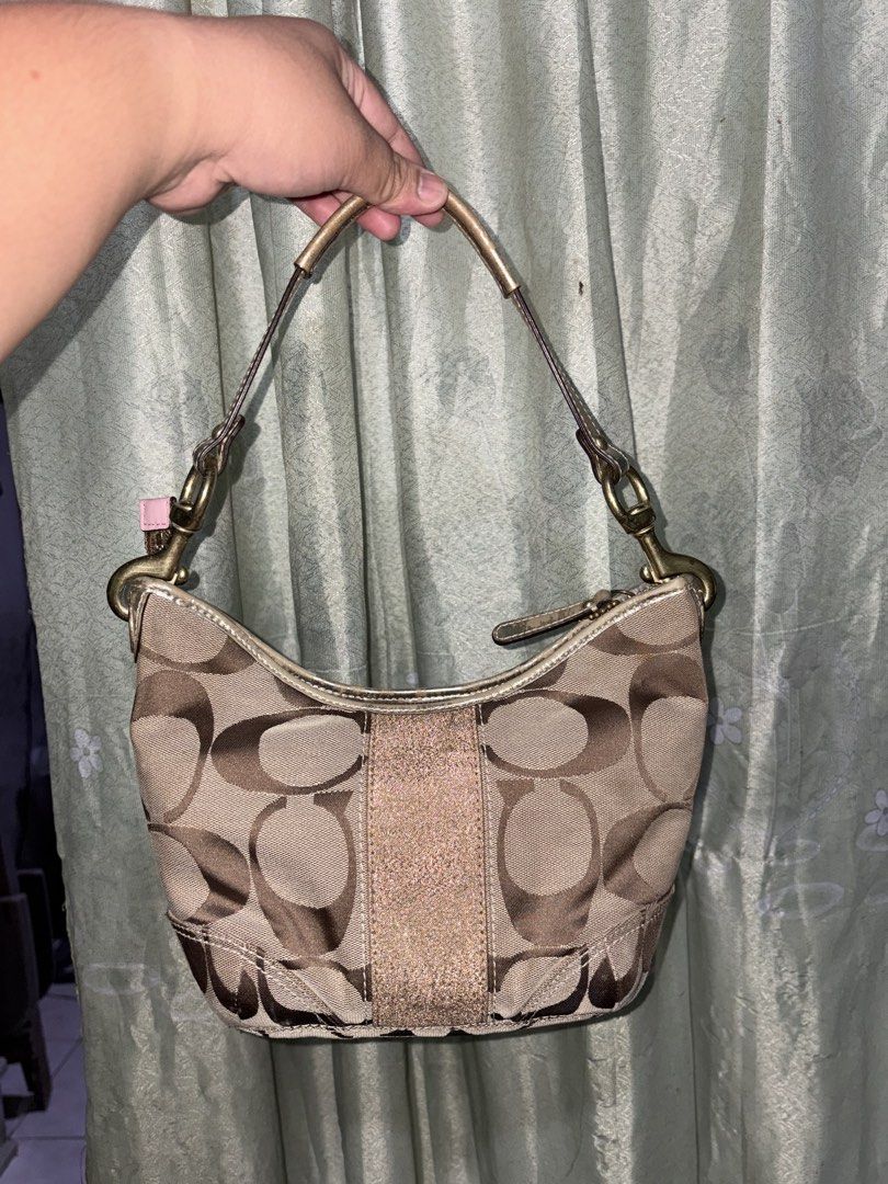 Coach Mini Shoulder Bag (Category: Shoulder Bags) located in Minalin. Submitted by warmmountain.21c981 (Listing ID 1464490389, Image 3). Description: Good condition and no rubs! • Clean and well-kept • Classic Coach monogram design • Brown/neutral color , the flaw po is just nag f fade yung metallic nya as u can see on the pic, but super okay since match sya sa color ng bag. RFS: Decluttering / no longer using it PM me if inch!.