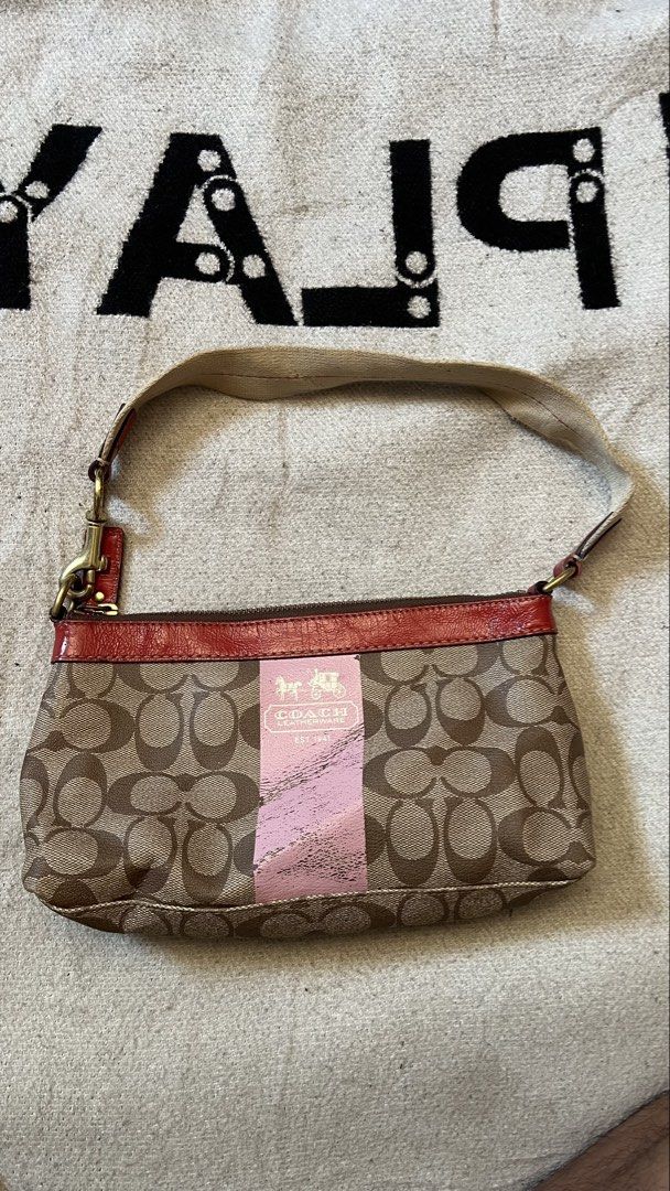 Coach Monogram Canvas & Leather Trim Shoulder Bag (Category: Luxury Bags & Wallets) located in Cagayan de Oro. Submitted by nelsondel21723 (Listing ID 1464387683, Image 1). Description: - Classic Coach monogram canvas shoulder bag - Features stylish red leather trim - Eye-catching pink stripe detail - Bright pink fabric interior lining - Secure zipper closure for your essentials - Ideal for everyday use - Approximate dimensions: 10 inches wide x 