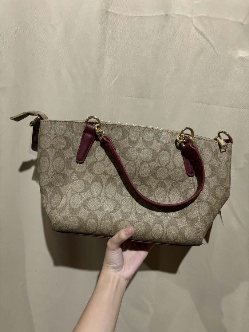Coach Monogram Canvas & Leather Trim Satchel Bag (Category: Luxury Bags & Wallets) located in Nagcarlan. Submitted by fiercewater-40fb (Listing ID 1464420628, Image 2). Description: - Classic Coach monogram canvas satchel - Burgundy leather trim and handles - Gold hardware - Zipper closure - Includes original tags - Great everyday bag.