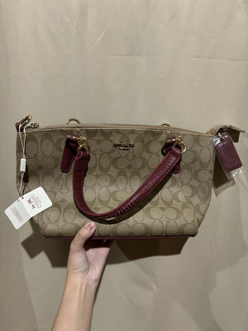 Coach Monogram Canvas & Leather Trim Satchel Bag (Category: Luxury Bags & Wallets) located in Nagcarlan. Submitted by fiercewater-40fb (Listing ID 1464420628, Image 1). Description: - Classic Coach monogram canvas satchel - Burgundy leather trim and handles - Gold hardware - Zipper closure - Includes original tags - Great everyday bag.