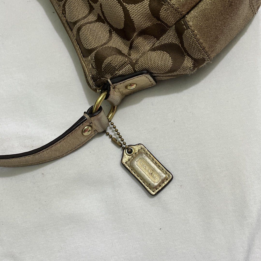 Coach Monogram Canvas & Metallic Gold Shoulder Bag (Category: Luxury Bags & Wallets) located in Manila. Submitted by xodaize (Listing ID 1464362204, Image 3). Description: - Classic Coach monogram canvas shoulder bag - Metallic gold accent strip across the front - Leather strap with gold-tone hardware - Signature Coach hangtag included Issue - signs of wear The condition of the bag is also disclosed on the pictures. .