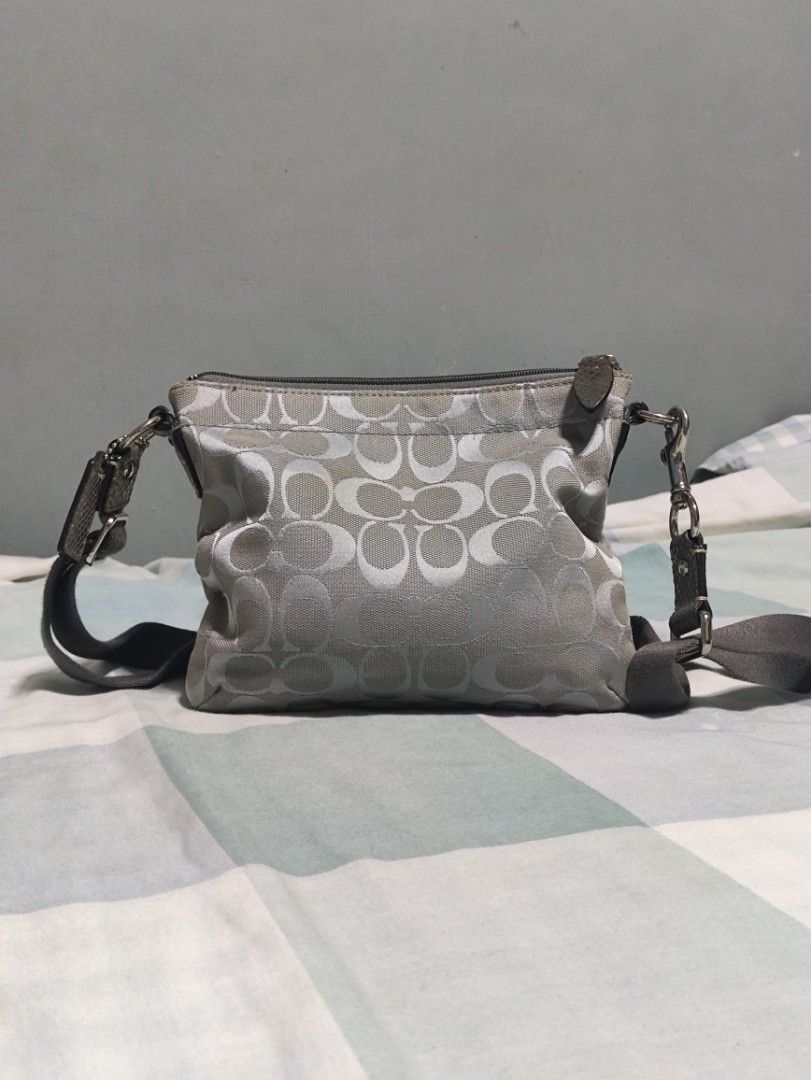 Coach Monogram Canvas Crossbody Bag Grey (Category: Luxury Bags & Wallets) located in Lucena. Submitted by cha_riz010726 (Listing ID 1464549095, Image 2). Description: - Grey Coach monogram canvas crossbody bag - Front pocket with secure turn-lock closure - Main compartment with zip-top opening - Adjustable shoulder strap for comfort - Includes authentic Coach hang tags - Compact and ideal for everyday use.