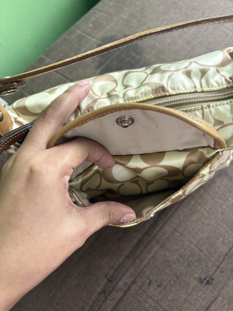 Coach Monogram Canvas Shoulder Bag (Category: Luxury Bags & Wallets) located in Manila. Submitted by catherinec05859 (Listing ID 1464452886, Image 2). Description: - Classic Coach shoulder bag - Beige and brown monogram pattern - Leather trim and strap - Zip main compartment - Front pocket with snap closure - Interior pocket - Shows some signs of wear on bottom corners and exterior - Still a great everyday bag.