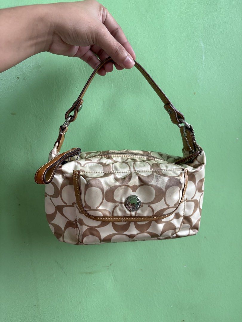 Coach Monogram Canvas Shoulder Bag (Category: Luxury Bags & Wallets) located in Manila. Submitted by catherinec05859 (Listing ID 1464452886, Image 1). Description: - Classic Coach shoulder bag - Beige and brown monogram pattern - Leather trim and strap - Zip main compartment - Front pocket with snap closure - Interior pocket - Shows some signs of wear on bottom corners and exterior - Still a great everyday bag.