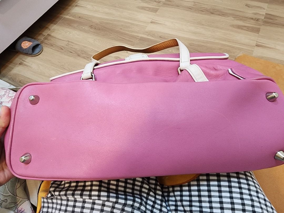 Coach Pink Leather Shoulder Bag (Category: Luxury Bags & Wallets) located in Caloocan City. Submitted by keenmoon.752ef0 (Listing ID 1464538954, Image 3). Description: - Stylish pink leather shoulder bag - White trim and buckle detail - Convenient top handle - Secure snap closure - Interior zippered pocket - Durable fabric lining - Minor signs of wear on bottom studs and leather - Ideal for everyday use.