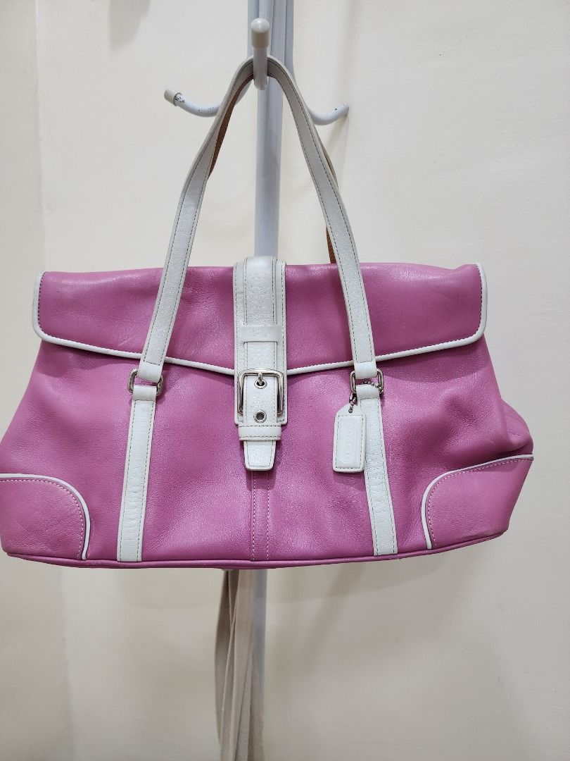 Coach Pink Leather Shoulder Bag (Category: Luxury Bags & Wallets) located in Caloocan City. Submitted by keenmoon.752ef0 (Listing ID 1464538954, Image 1). Description: - Stylish pink leather shoulder bag - White trim and buckle detail - Convenient top handle - Secure snap closure - Interior zippered pocket - Durable fabric lining - Minor signs of wear on bottom studs and leather - Ideal for everyday use.