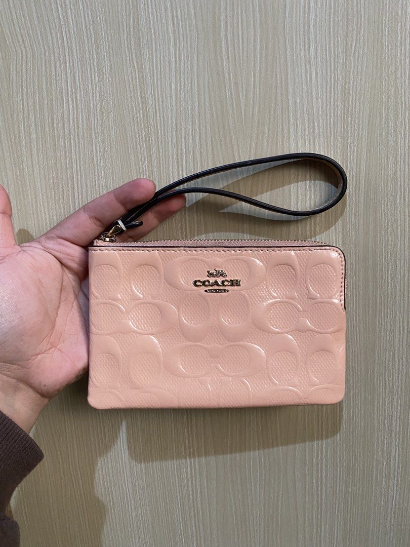 Coach Pink Monogram Wristlet Pouch (Category: Luxury Bags & Wallets) located in La Trinidad. Submitted by kinleyky (Listing ID 1464388398, Image 1). Description: - Coach wristlet in a lovely light pink. - Features the iconic Coach C monogram embossed all over. - Secure zip closure with a convenient wrist strap. - Interior pocket for organizing small items. - Comes with an authenticity card for peace of mind. - Ideal for carrying your daily essent