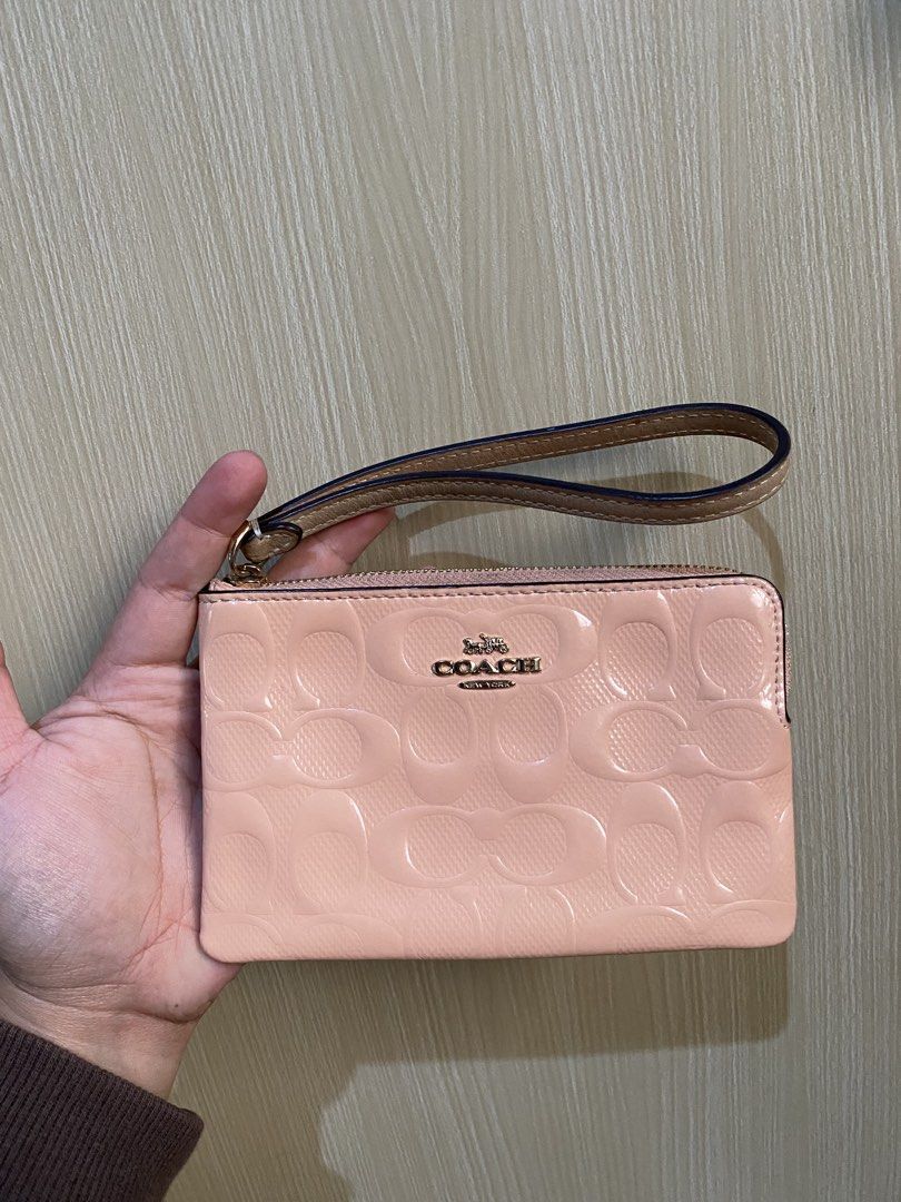 Coach Pink Monogram Wristlet Pouch (Category: Luxury Bags & Wallets) located in La Trinidad. Submitted by kinleyky (Listing ID 1464388398, Image 3). Description: - Coach wristlet in a lovely light pink. - Features the iconic Coach C monogram embossed all over. - Secure zip closure with a convenient wrist strap. - Interior pocket for organizing small items. - Comes with an authenticity card for peace of mind. - Ideal for carrying your daily essent