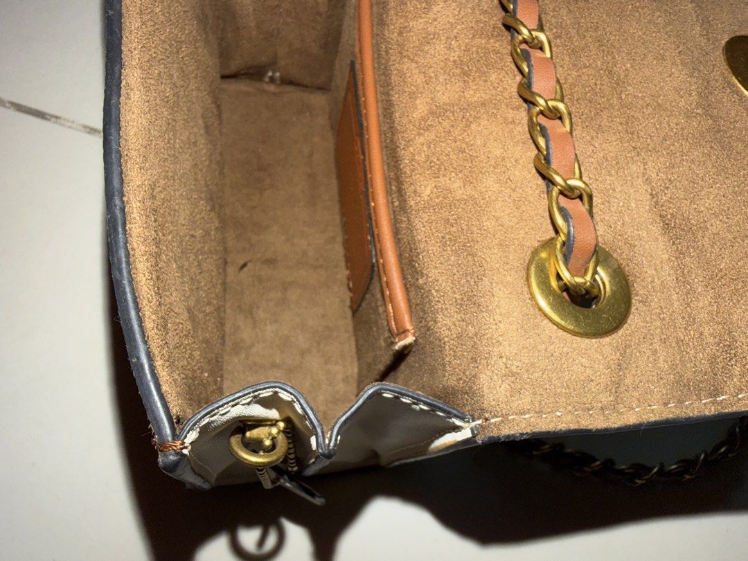 Coach Signature Canvas & Leather Chain Bag (Category: Luxury Bags & Wallets) located in Santa Rosa. Submitted by decluttering_. (Listing ID 1464568277, Image 3). Description: - Authentic Coach bag - Signature print with white leather flap - Gold chain strap with leather accents - Brown suede-like interior lining - Small interior compartment - Secure clasp closure - Ideal for carrying essentials.