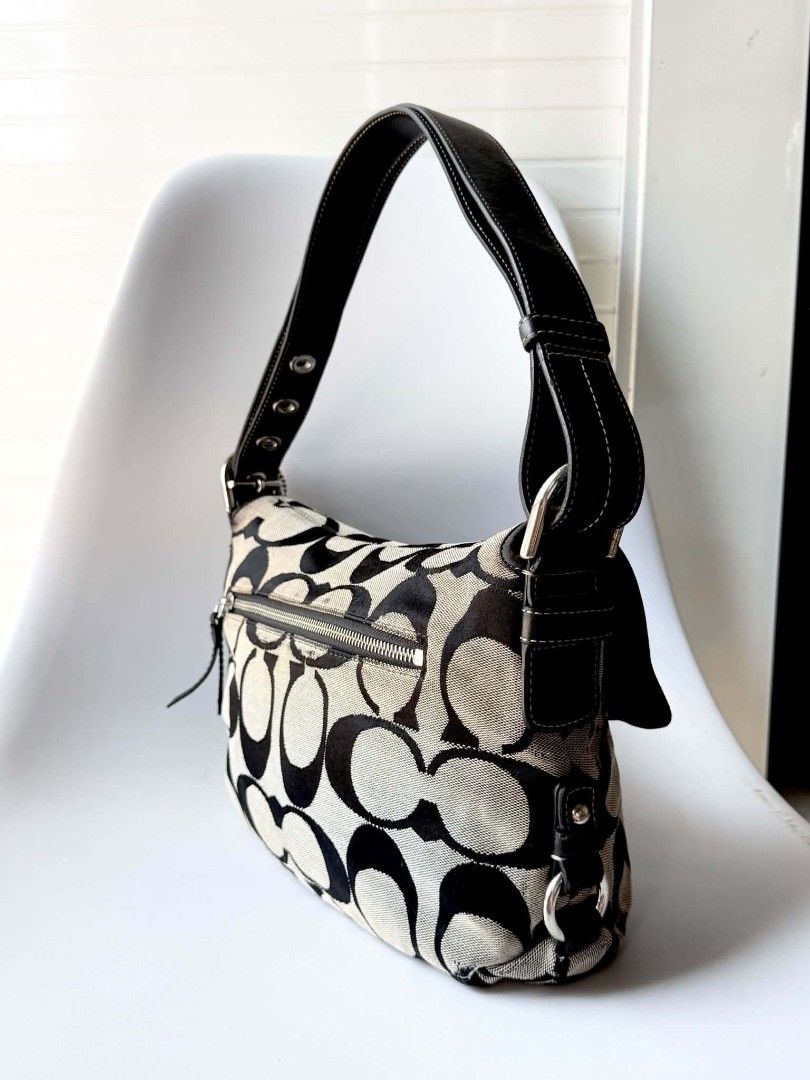 Coach Signature Monogram Canvas Shoulder Bag (Category: Luxury Bags & Wallets) located in Lucena. Submitted by pureg0od (Listing ID 1464397803, Image 3). Description: - Classic Coach shoulder bag - Signature monogram canvas with black leather trim - Silver hardware - Secure turn-lock closure - Convenient zippered pocket on the back - Interior features a zippered pocket and slip pockets - Flaws Sign of usage - Approximate dimensions: 12" (L) x 7" 
