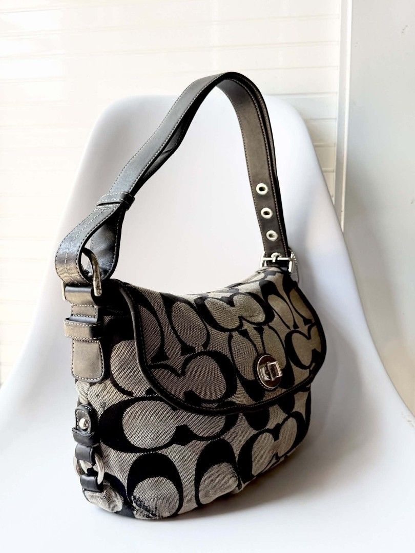 Coach Signature Monogram Canvas Shoulder Bag (Category: Luxury Bags & Wallets) located in Lucena. Submitted by pureg0od (Listing ID 1464397803, Image 2). Description: - Classic Coach shoulder bag - Signature monogram canvas with black leather trim - Silver hardware - Secure turn-lock closure - Convenient zippered pocket on the back - Interior features a zippered pocket and slip pockets - Flaws Sign of usage - Approximate dimensions: 12" (L) x 7" 