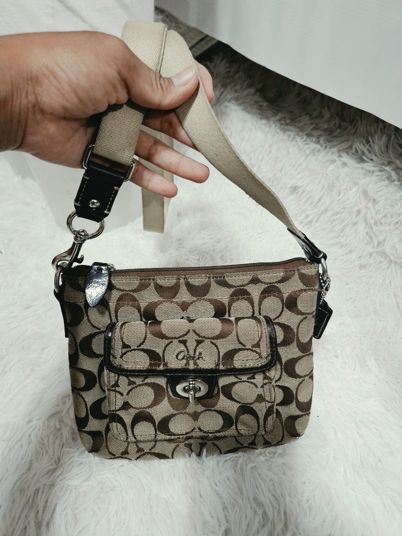 Coach Signature Monogram crossbody Bag (Category: Luxury Bags & Wallets) located in Cavite. Submitted by liveriver_514fd1 (Listing ID 1464398457, Image 3). Description: - Authentic Coach Crossbody - Signature monogram print (brown/tan) - Front flap pocket with turn-lock closure - Zippered main compartment - Detachable strap included - Ideal for carrying essentials.
