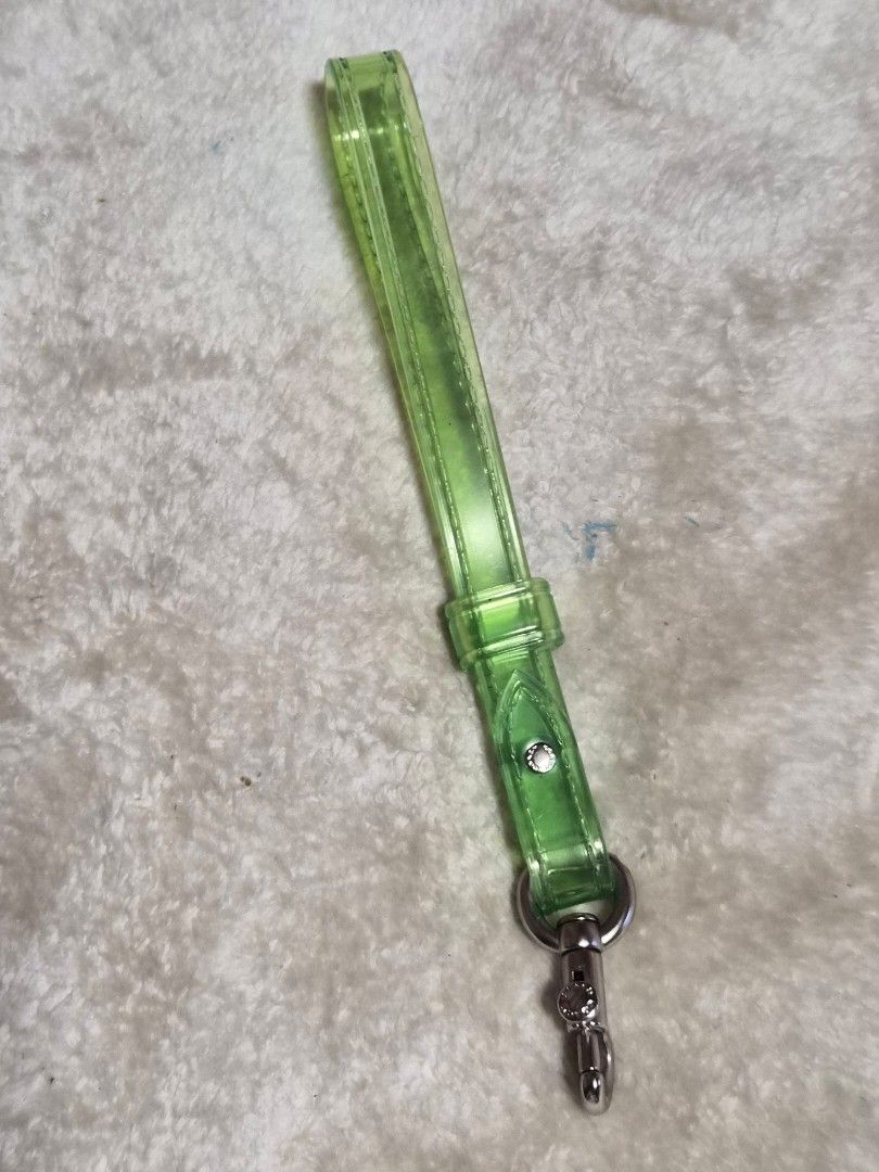 Coach Translucent Green Keychain Strap (Category: Luxury Accessories) located in Mandaue City. Submitted by chuchi152615 (Listing ID 1464403181, Image 1). Description: - Coach keychain strap - Translucent green color - Silver hardware with Coach logo - Versatile: Attaches to bags or keys - Adds a pop of color - Clean and simple design.