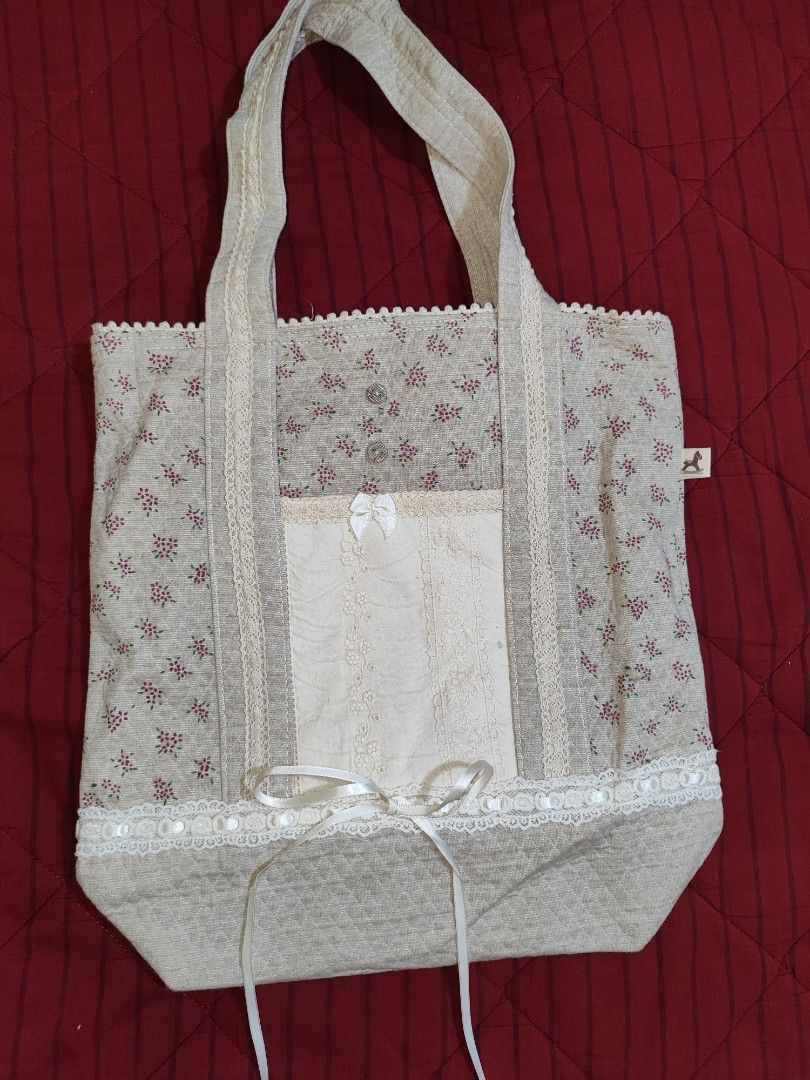 Coquette tote bag (Category: Tote Bags) located in Iloilo. Submitted by cynehllevie (Listing ID 1464367620, Image 1). Description: 🍥 lowered price (much cheaper now than before) 🍥 really pretty in personal! 🍥 Length: 13.5 inch 🍥 Width: 12.5 inch note: measurement may slightly be a bit different.