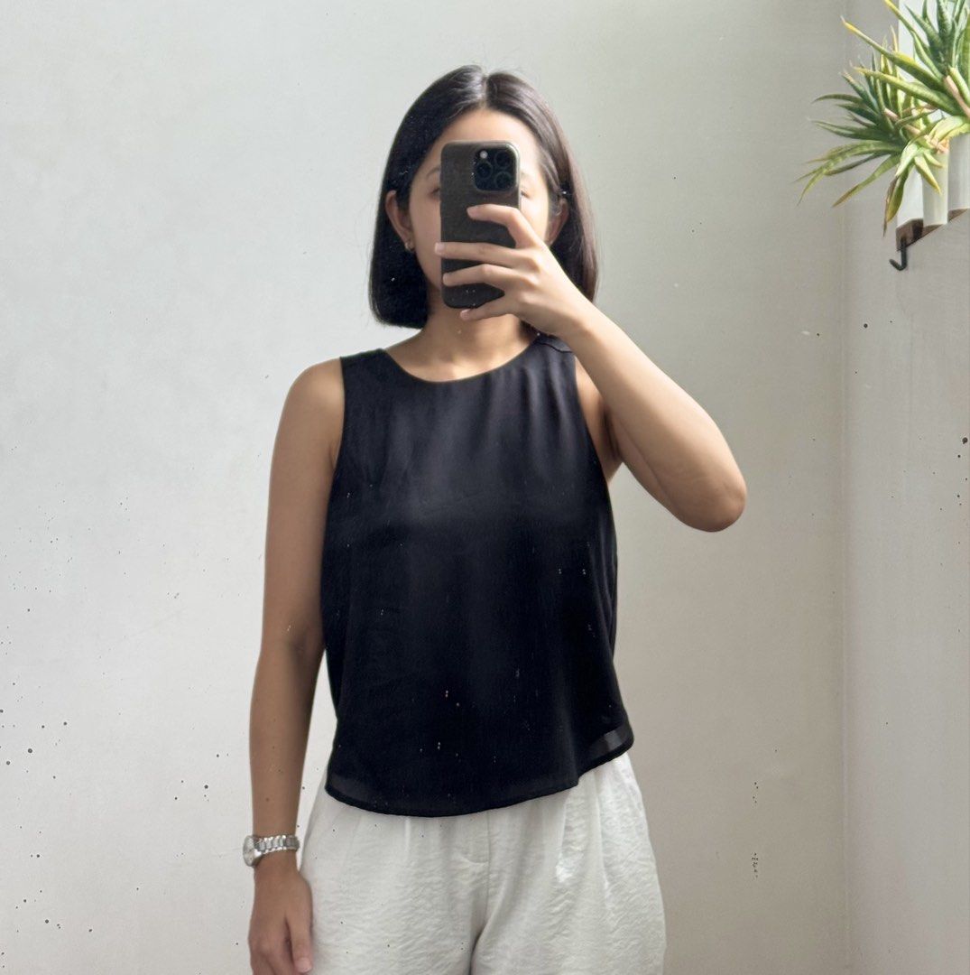 Cotton On Black Sleeveless Top (Category: Sleeveless) located in Bulacan. Submitted by _arislmt (Listing ID 1464417939, Image 1). Description: - Brand: Cotton On - Type: Sleeveless Tank Top - Color: Black - Style: Simple and classic - Versatility: Perfect for layering or wearing on its own - Pairing: Easily matches with any outfit - Fits XS.