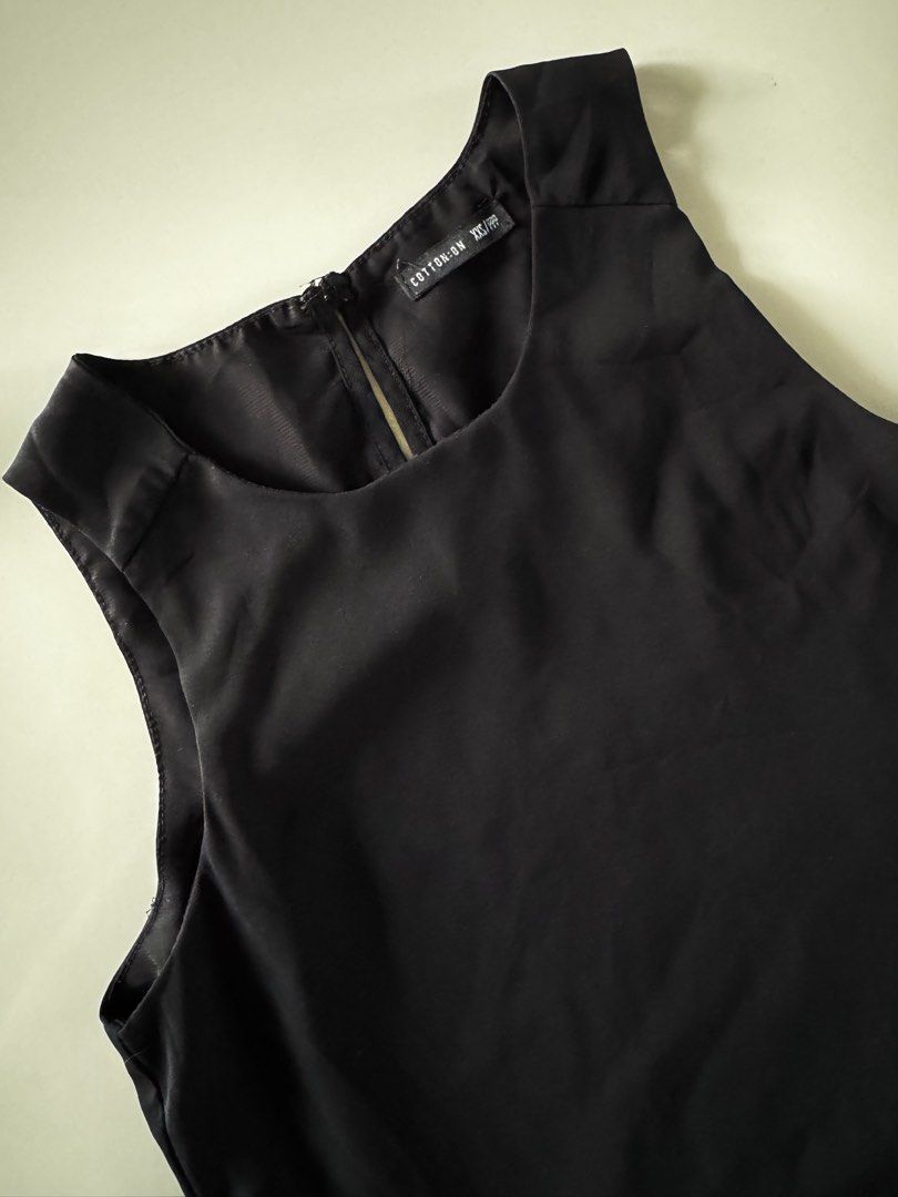 Cotton On Black Sleeveless Top (Category: Sleeveless) located in Bulacan. Submitted by _arislmt (Listing ID 1464417939, Image 2). Description: - Brand: Cotton On - Type: Sleeveless Tank Top - Color: Black - Style: Simple and classic - Versatility: Perfect for layering or wearing on its own - Pairing: Easily matches with any outfit - Fits XS.