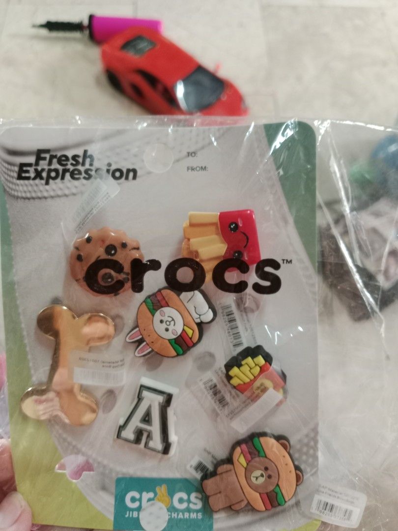 Crocs Charms Jibbitz Food Theme (Category: Charms) located in Manila. Submitted by jamielleej87951 (Listing ID 1464415001, Image 1). Description: - Set of Crocs charms for personalization. - Includes fun food designs: fries, burger, cookie. - Also features an alphabet 'A' charm and a bone shape. - Easy to attach and remove from Crocs shoes. - Perfect for kids and adults who love to customize their footwear..