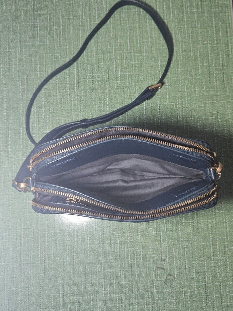 CUORONNE Blue Sling Bag (Category: Cross-body Bags) located in Pasig City. Submitted by ciannysshop (Listing ID 1464533476, Image 3). Description: lile new multiple pockets detachable sling magnet middle closure smooth zipper adjustable strap gold hardware inner pockets signs of use on the metal parts .