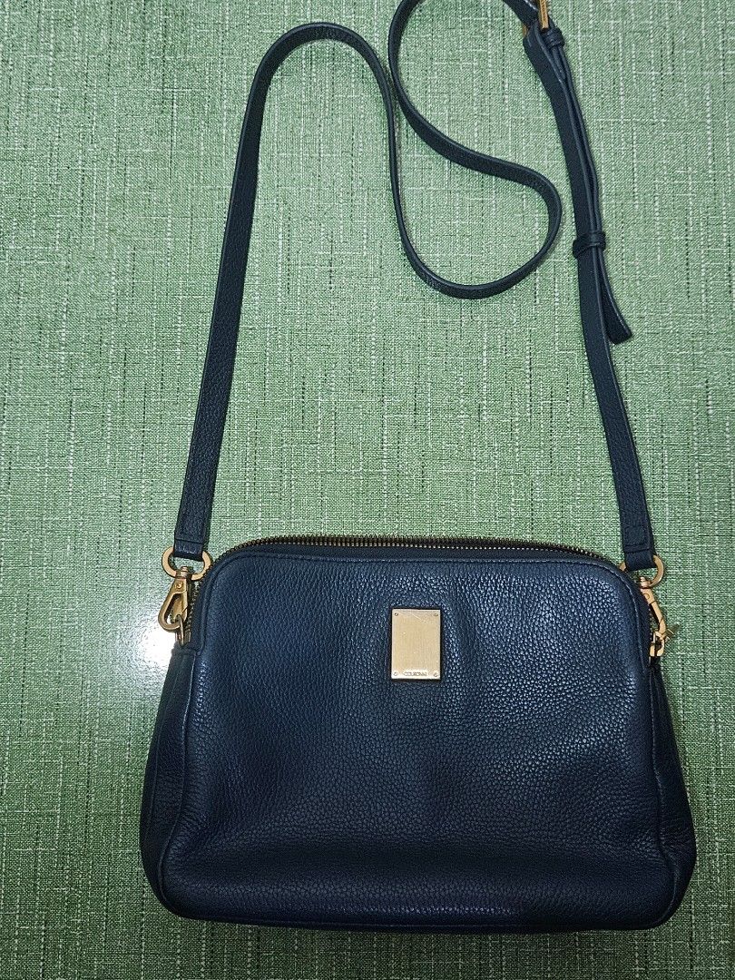 CUORONNE Blue Sling Bag (Category: Cross-body Bags) located in Pasig City. Submitted by ciannysshop (Listing ID 1464533476, Image 1). Description: lile new multiple pockets detachable sling magnet middle closure smooth zipper adjustable strap gold hardware inner pockets signs of use on the metal parts .
