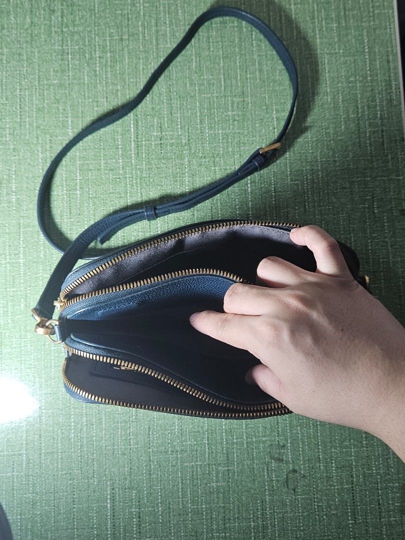 CUORONNE Blue Sling Bag (Category: Cross-body Bags) located in Pasig City. Submitted by ciannysshop (Listing ID 1464533476, Image 2). Description: lile new multiple pockets detachable sling magnet middle closure smooth zipper adjustable strap gold hardware inner pockets signs of use on the metal parts .