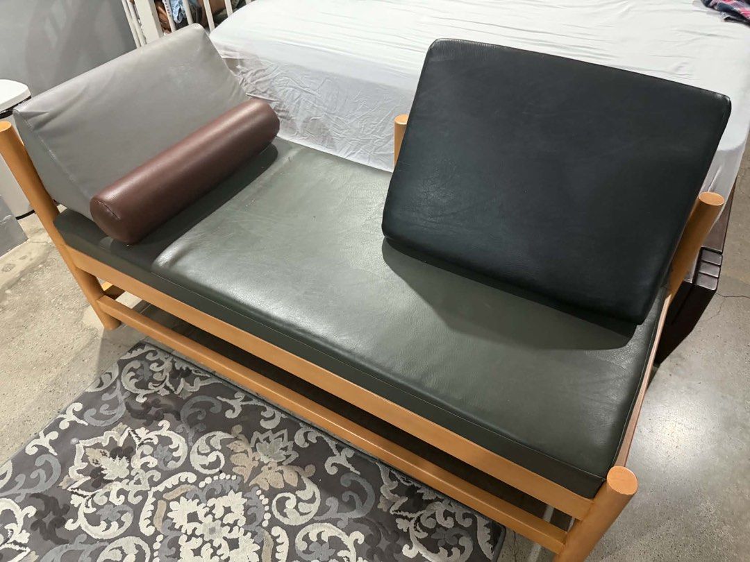 Custom Wooden Frame Daybed with Cushions (Category: Bed Frames & Mattresses) located in Quezon City. Submitted by thejowsh (Listing ID 1464386343, Image 3). Description: - Wooden frame daybed with natural finish - Dark grey upholstery - Includes one bolster pillow - Includes two back cushions (grey and black) - Simple, modern design - Ideal for lounging or extra seating - Fits most living spaces.