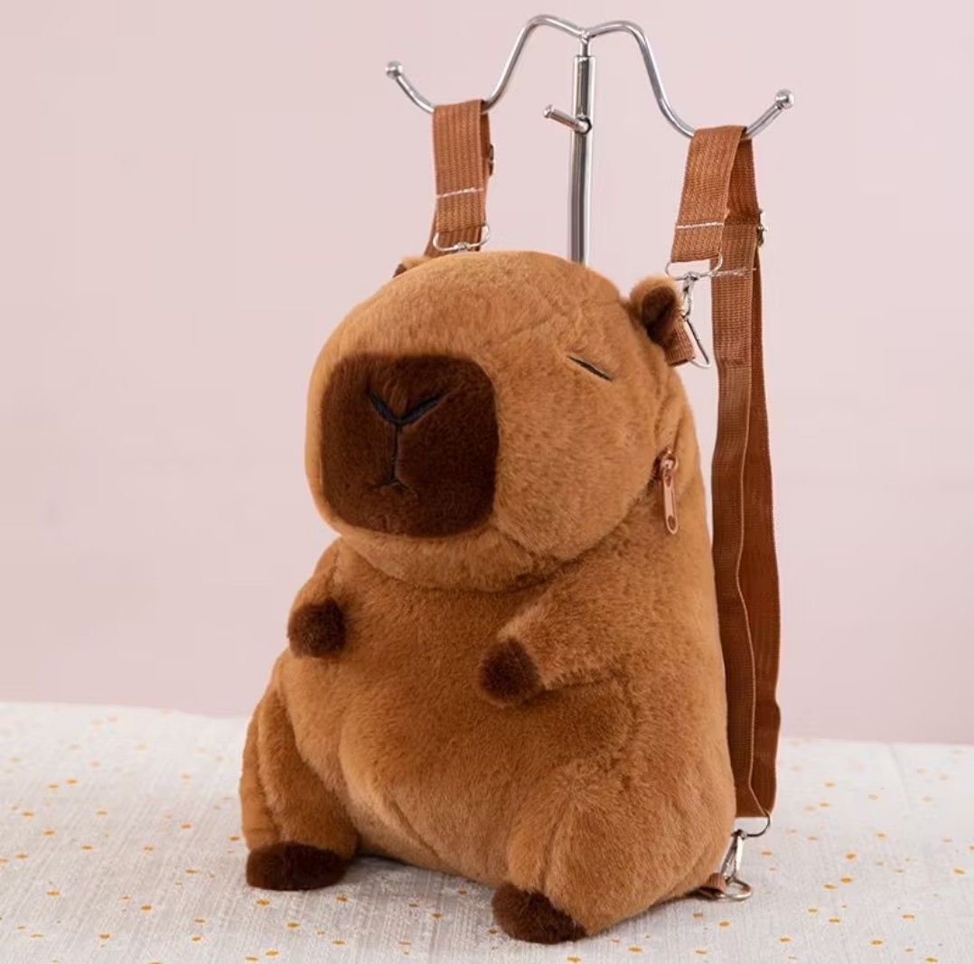 Cute Capybara Plush Backpack with Accessories (Category: Plushies & Soft Toys) located in Antipolo. Submitted by jovy24 (Listing ID 1464510494, Image 1). Description: - Adorable capybara plush backpack - Made with soft and fuzzy material - Includes cute attachable accessories: burger, fries, flower, and orange - Ideal for kids or anyone who loves cute items - Features adjustable straps for a comfortable fit - Zipper closure for the main compartme