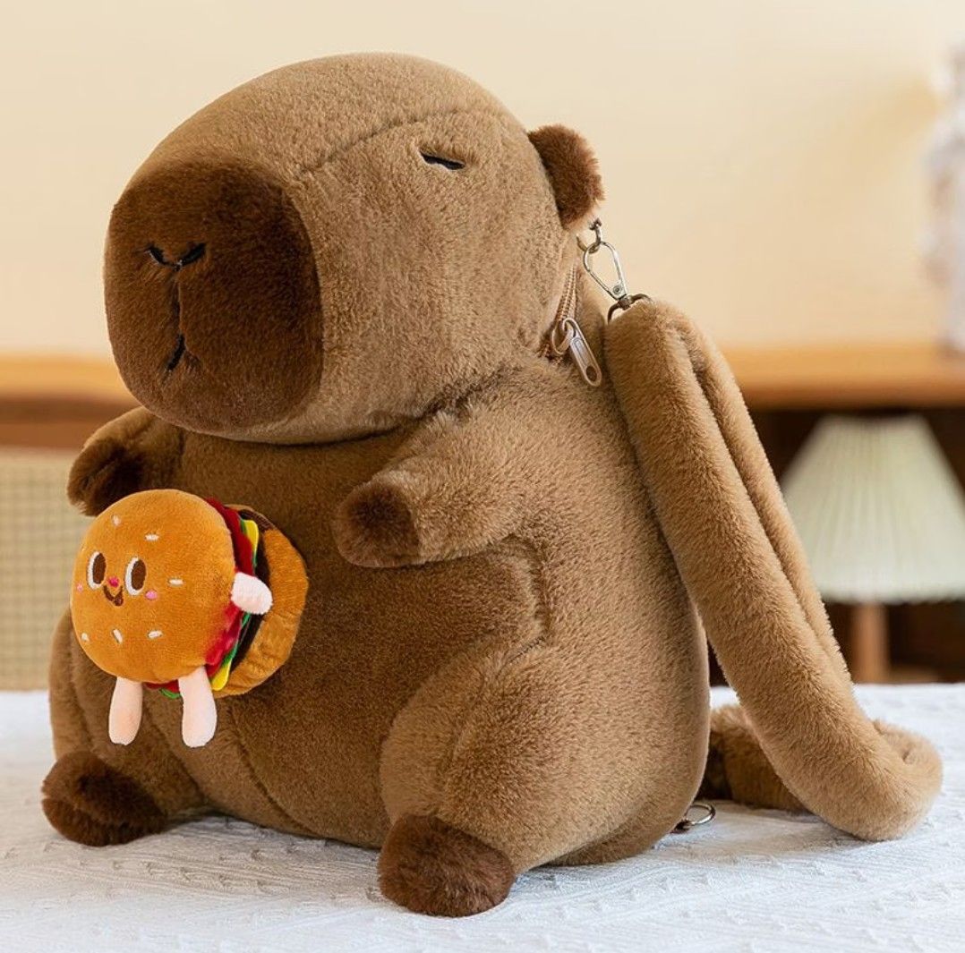 Cute Capybara Plush Backpack with Accessories (Category: Plushies & Soft Toys) located in Antipolo. Submitted by jovy24 (Listing ID 1464510494, Image 3). Description: - Adorable capybara plush backpack - Made with soft and fuzzy material - Includes cute attachable accessories: burger, fries, flower, and orange - Ideal for kids or anyone who loves cute items - Features adjustable straps for a comfortable fit - Zipper closure for the main compartme