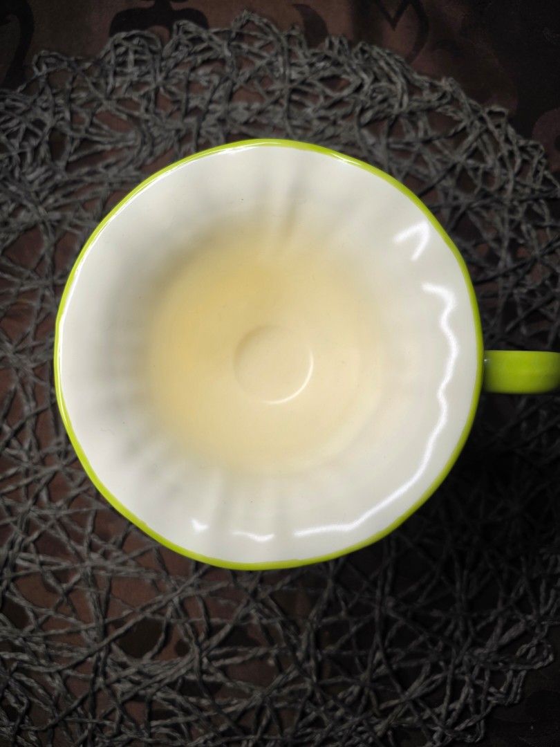 Lily of the Valley Mug (Category: Coffee & Tea Tableware) located in Zamboanga. Submitted by lunavinum (Listing ID 1464443733, Image 2). Description: - peronal fave - Features delicate sculpted lily of the valley flowers on the handle. - Cream white with a fluted design. - Vibrant green rim and base. - Adds a charming touch to any table setting. - approx meas 3.3x4.1.