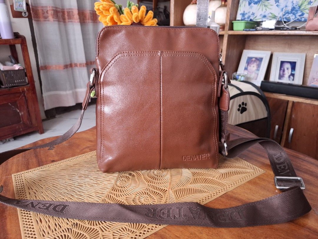 DENATER Brown Leather Crossbody Bag (Category: Sling Bags) located in Libon. Submitted by jaladzarmi80045 (Listing ID 1464361674, Image 1). Description: - DENATER brown leather crossbody bag - Adjustable strap with brand name - Main compartment with zipper closure - Front pocket for quick access - Perfect for everyday use - Please check photos for condition details.