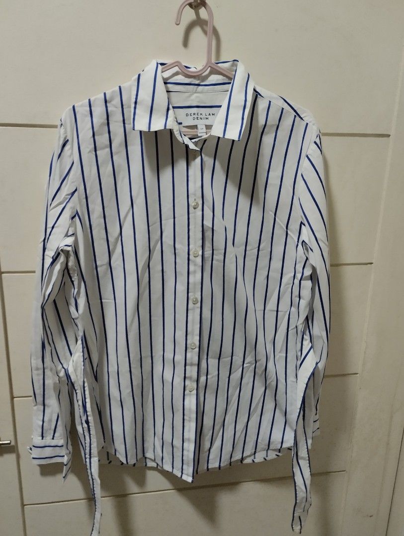 Derek Lam Denim Striped Button-Up Shirt S/P (Category: Blouses) located in Mabalacat. Submitted by uniqlover (Listing ID 1464417735, Image 1). Description: - Derek Lam white shirt with blue stripes - Button-up front - Adjustable tie at the back to cinch the waist - Long sleeves with button cuffs - Side slits at the hem - Size S/P.