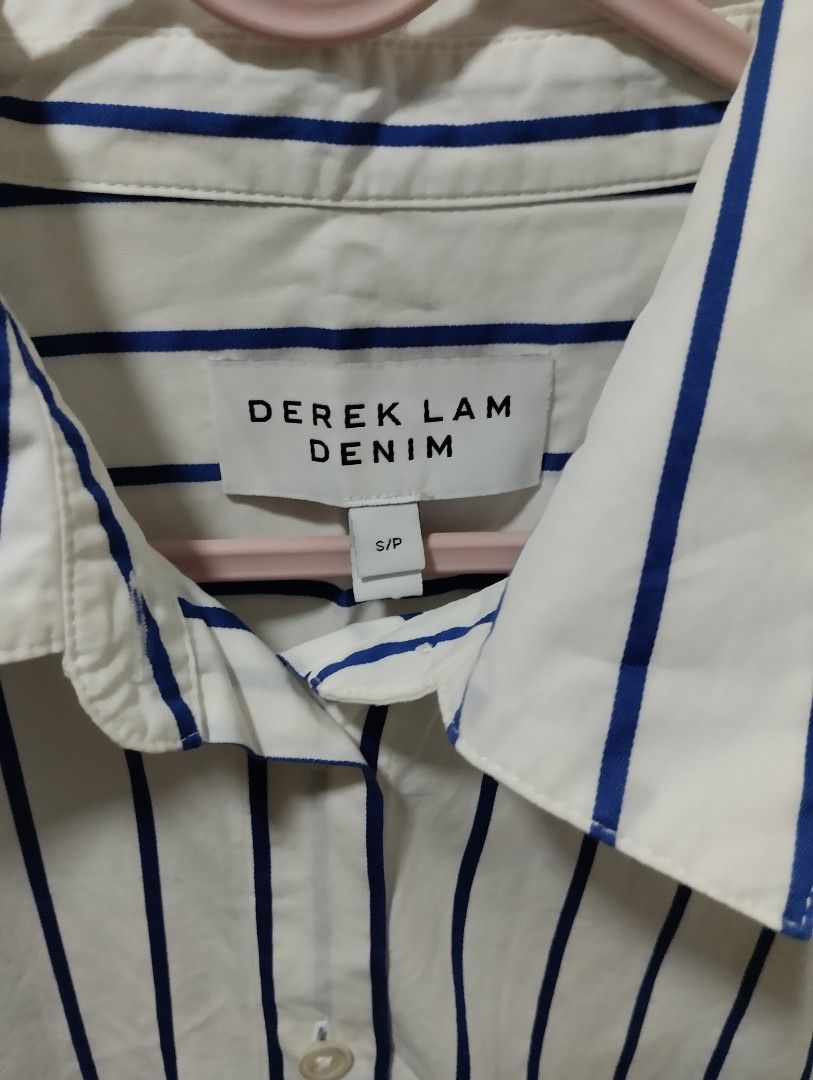 Derek Lam Denim Striped Button-Up Shirt S/P (Category: Blouses) located in Mabalacat. Submitted by uniqlover (Listing ID 1464417735, Image 2). Description: - Derek Lam white shirt with blue stripes - Button-up front - Adjustable tie at the back to cinch the waist - Long sleeves with button cuffs - Side slits at the hem - Size S/P.