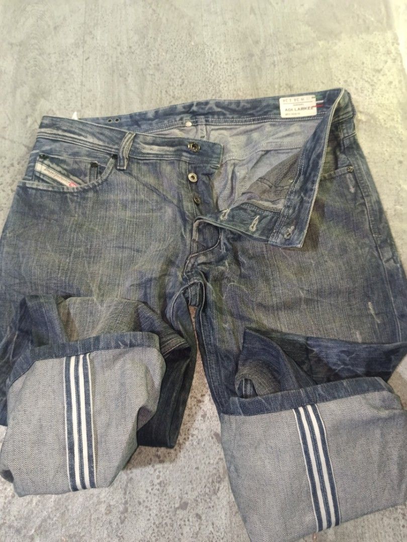 Diesel Jeans - Distressed Blue Denim (Category: Jeans) located in Carcar. Submitted by rolandobac92675 (Listing ID 1464395213, Image 2). Description: - Blue wash Diesel jeans - Distressed look with fading and creasing - Straight leg cut - Cuffed hems with striped detail - Button fly closure - Ideal for everyday wear.