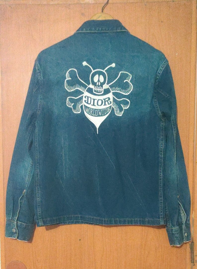 Dior Denim Jacket with Bee and Skull Graphic (Category: Coats, Jackets and Outerwear) located in Bago City. Submitted by louielinco (Listing ID 1464463598, Image 2). Description: - Authentic Dior X Shawn Stussy Selvedge denim jacket - Size: 44 - Iconic bee and skull graphic on the back - Dior Paris logo on the front - Made in Japan - A must-have for any Dior collector.