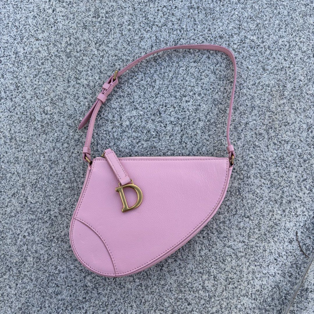 Dior Saddle Bag Pink Leather (Category: Luxury Bags & Wallets) located in Alcala. Submitted by dela.sole (Listing ID 1464451354, Image 1). Description: - Authentic Dior Saddle bag - Lovely pastel pink color - Iconic 'D' charm - CD zipper pull -Christian dior under zip - Interior card slots - Soft and supple leather - Perfect for everyday or nights out - Includes dust bag.