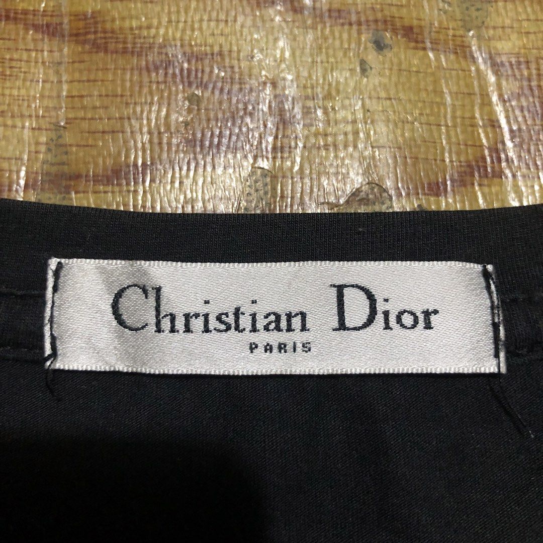 Dior x Kaws Baby Tops (Category: Shirts) located in Dasmarinas. Submitted by corenyxmessy_3rd_account (Listing ID 1464407067, Image 3). Description: This is a black KAWS x Dior Logo T-Shirt featuring the signature pink KAWS-style “DIOR” lettering and an embroidered cartoon bee detail. width - 18 length - 23.