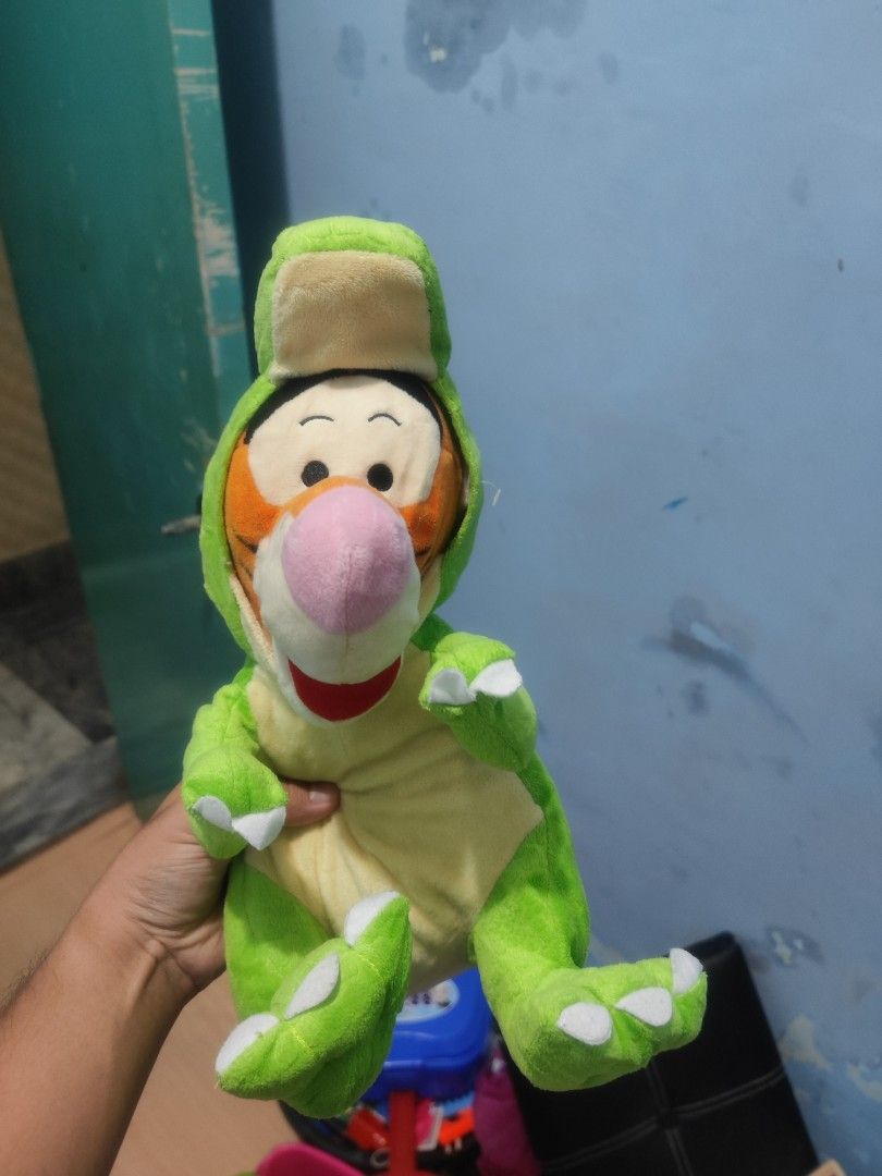 Disney Tigger Dinosaur Costume Plush Toy (Category: Plushies & Soft Toys) located in Iligan City. Submitted by sneakymagician (Listing ID 1464436615, Image 1). Description: - Adorable Tigger plush toy - Dressed in a cute dinosaur costume - Super soft and cuddly - Approximately 10-12 inches tall - Ideal for Winnie the Pooh fans - Great for display or playtime - A fun collectible item.